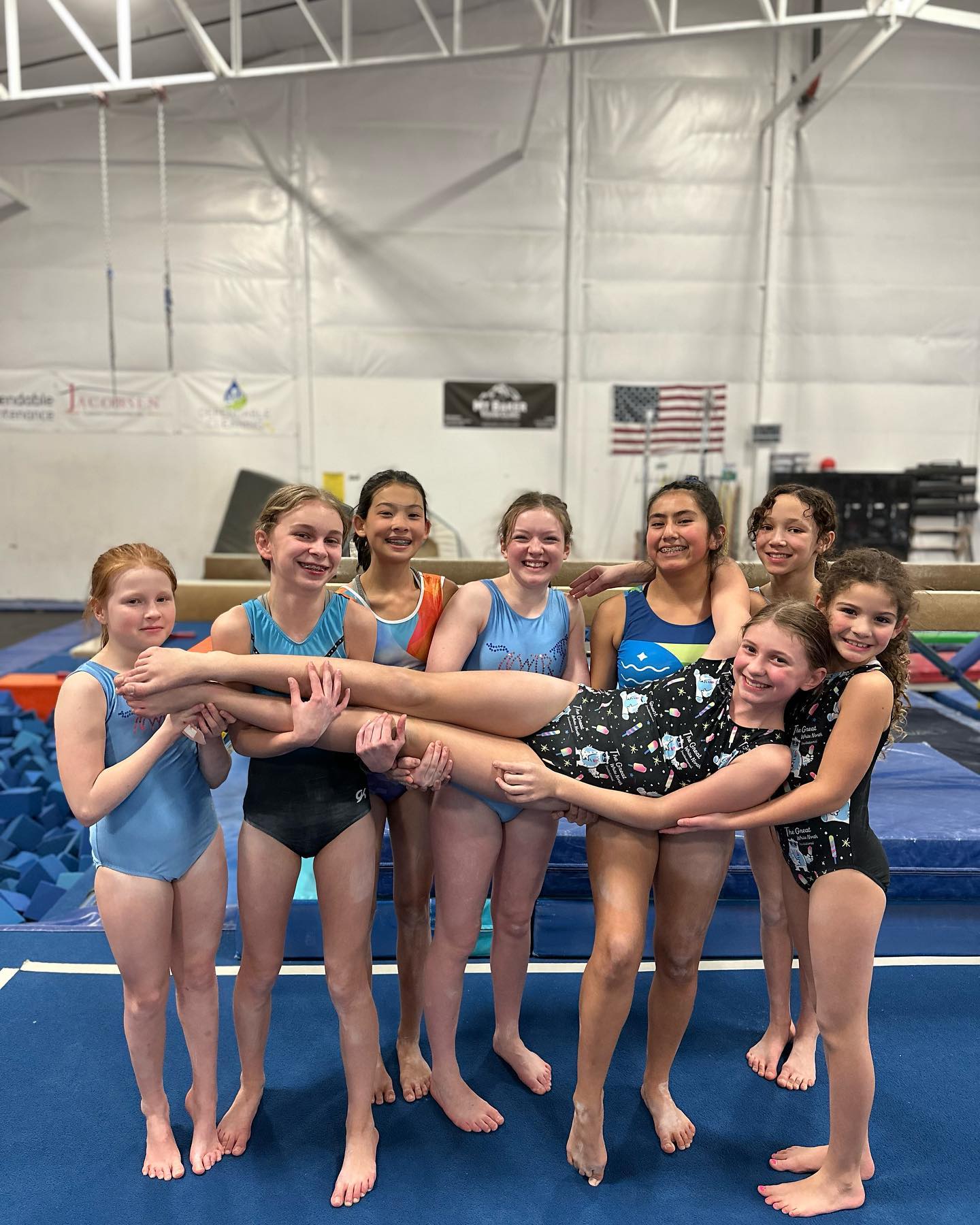 Gym Star gymnasts holding up a teammate